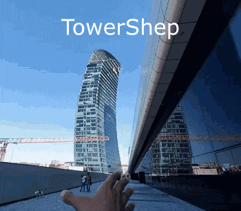a person 's hand is pointing up at a tall building that says towershep on the top