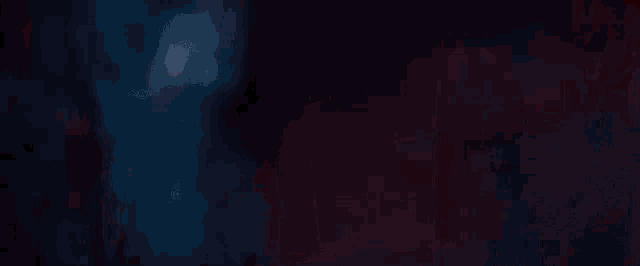 a close up of a red light shining on a dark background