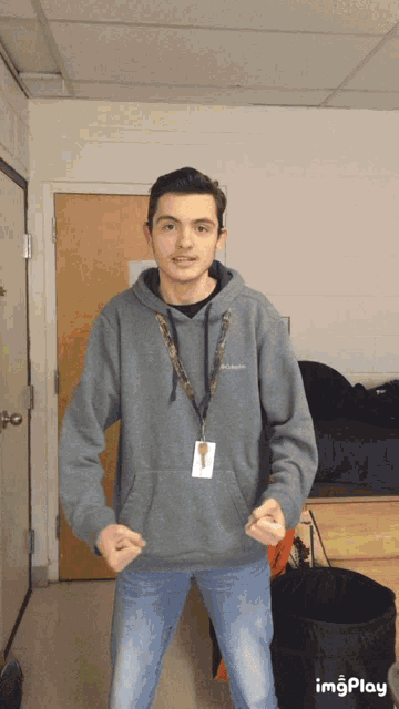 a man wearing a columbia sweatshirt and a lanyard with a key