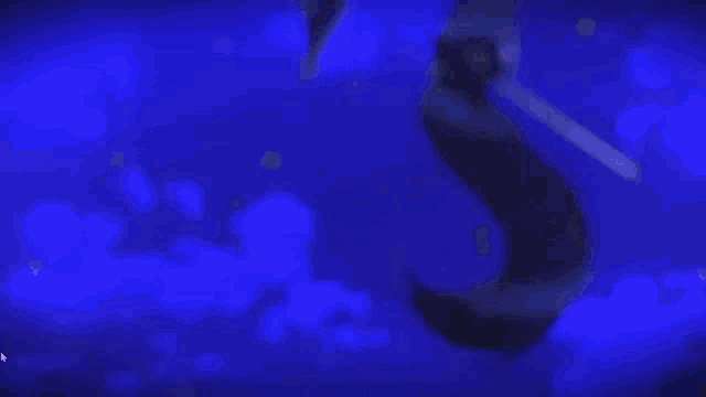 a blurry picture of a person standing in a dark room with blue lights