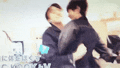 two men are hugging each other in a blurry picture .