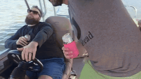 a man wearing a shirt that says stead is holding a can