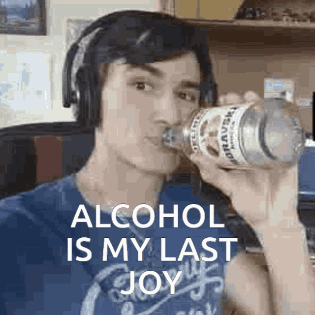 a man wearing headphones is drinking from a bottle with the words alcohol is my last joy above him .