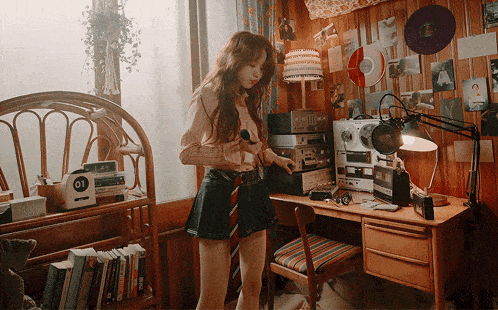 a woman is standing in a room with a clock that says 01