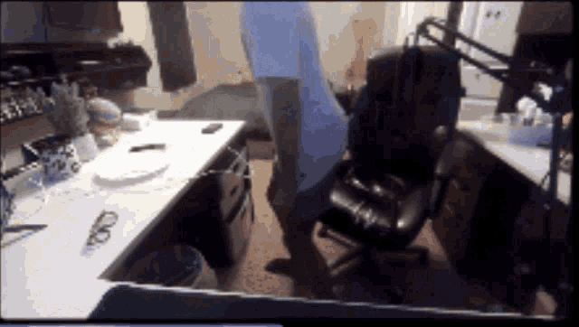 a person sitting on a chair in front of a desk with a plate on it