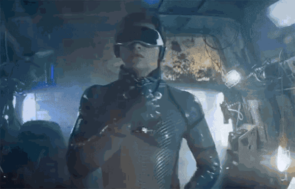 a man wearing a virtual reality headset is standing in a room .