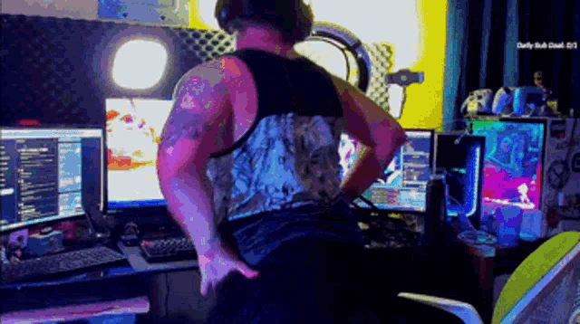 a man is standing in front of a computer monitor with a daily rush logo on the bottom