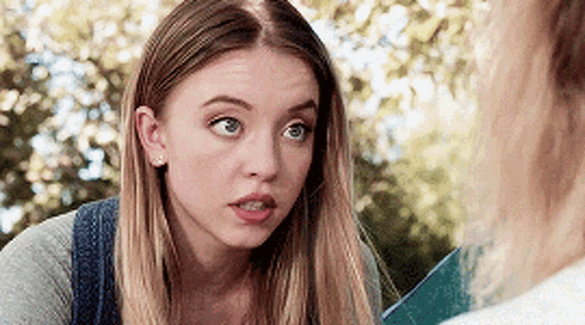 a close up of a woman 's face looking at another woman .