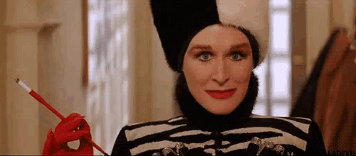 a woman in a zebra print costume is holding a cigarette and a red cigarette holder .