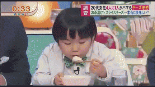 a little boy is eating a bowl of food with chopsticks and a time of 1:33 on the screen