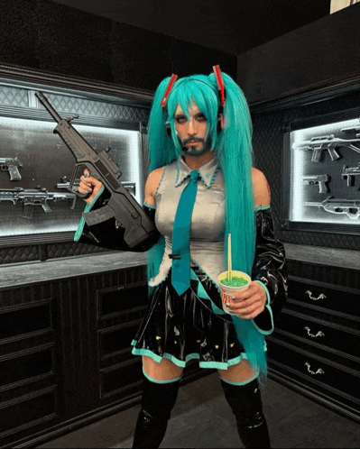 a man in a hatsune miku costume holds a gun and a cup of green tea