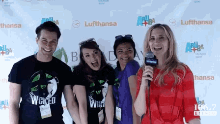 a group of people standing in front of a wall that says lufthansa on it