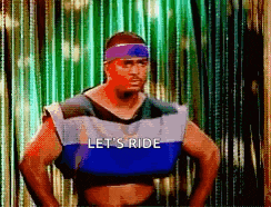 a man wearing a blue vest that says let 's ride on it
