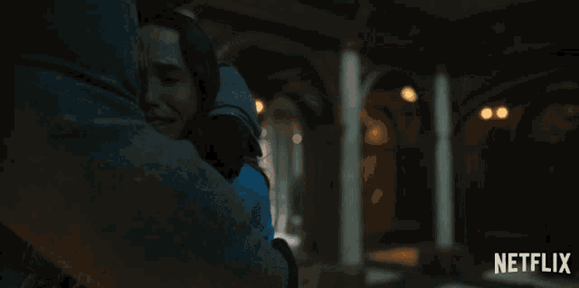 a netflix ad shows a man hugging a woman in a dark room