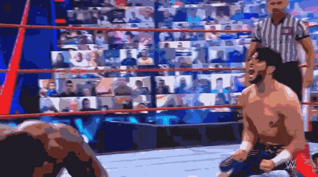 a man in a wrestling ring with a referee behind him and the word w on the bottom