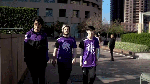 three people wearing purple shirts with the number 9 on them