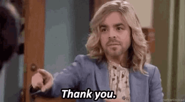 a man with long blonde hair and a beard is saying thank you .