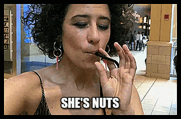a woman with curly hair is eating a lollipop with the words she 's nuts below her