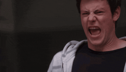 a man in a white hoodie screams with his mouth open