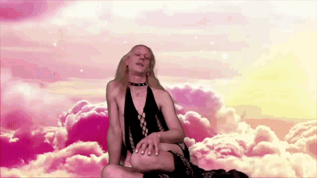 a woman is laying on a man 's lap in a cloudy sky