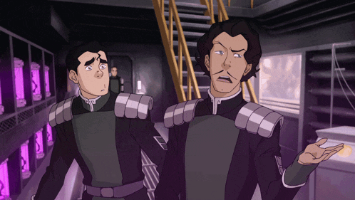 two men are standing next to each other in a room with purple walls