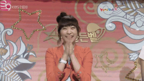a woman stands in front of a kbs 2 hd sign