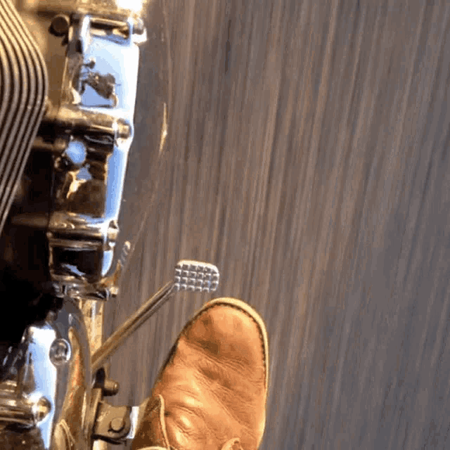 a person riding a motorcycle with their foot on the brake