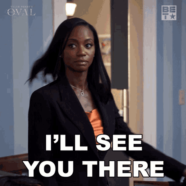 a woman says " i 'll see you there " while wearing a black suit