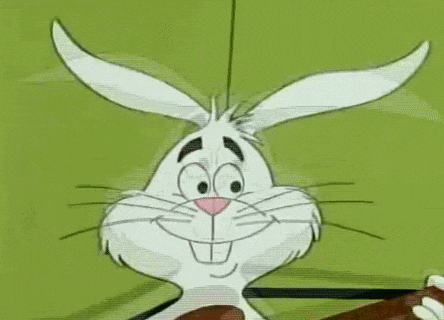 a cartoon rabbit is making a funny face while holding a stick in its mouth .