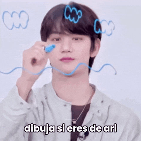 a young man is drawing on a whiteboard with the words dibuja si eres de ari