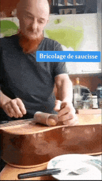 a man with a beard is working on a guitar with the words bricolage de saucisse on the bottom