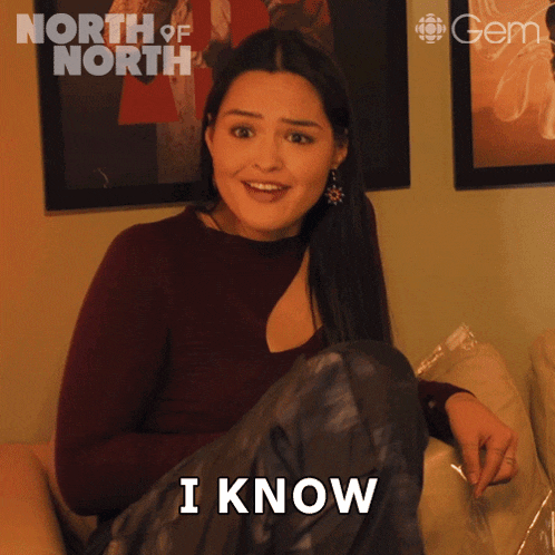 a woman sitting on a couch with a surprised look on her face says i know