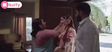 a man and woman are standing next to each other in a living room .