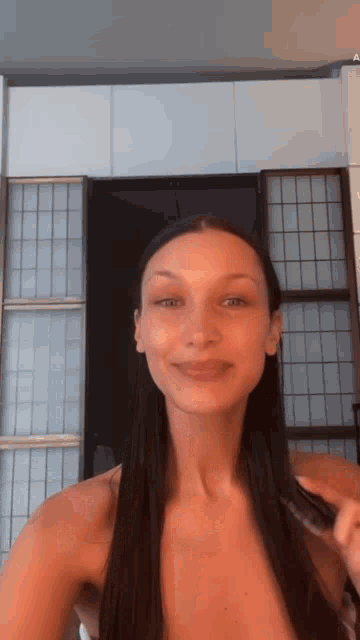 a woman is taking a selfie in front of a door .