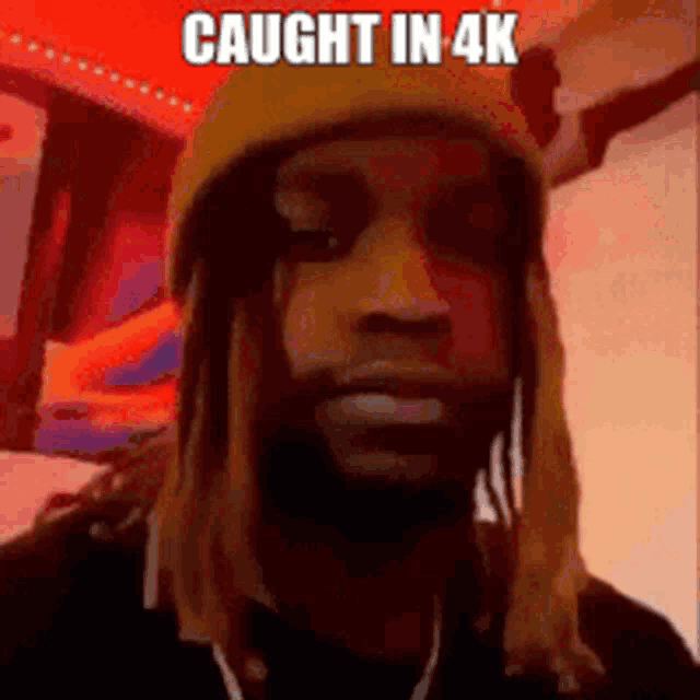 a man with dreadlocks wearing a yellow beanie and a dog on his head is being caught in 4k .