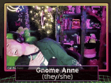 a video of a person laying down with the words " gnome anne ( they / she ) " at the top