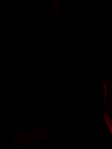 a close up of a person 's face with a red light behind them