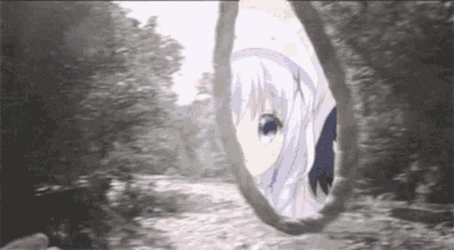 a black and white photo of a girl looking through a hole in a rope .