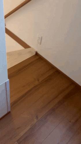 a wooden floor with a white wall and the number 21 on it