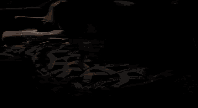 a blurry picture of a dark room with a few lights on the ceiling .