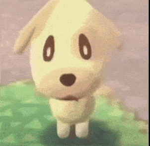 a stuffed dog with black eyes and a red collar is standing on a green field .
