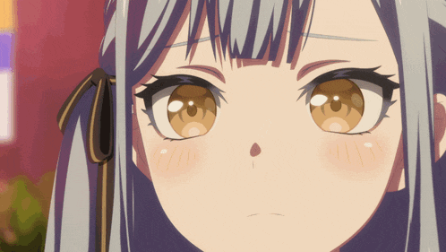 a close up of a girl 's face with a bow in her hair