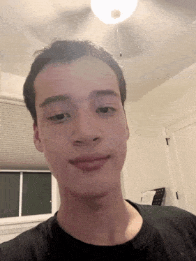 a young man taking a selfie in a room
