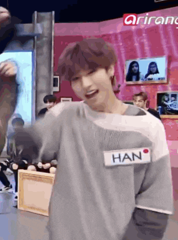 a young man wearing a sweater with a name tag that says han