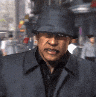 a man wearing a black hat and a black coat