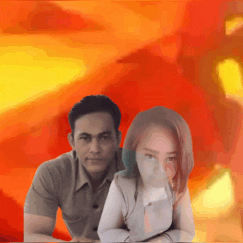 a man and a woman are posing for a picture in front of a red background