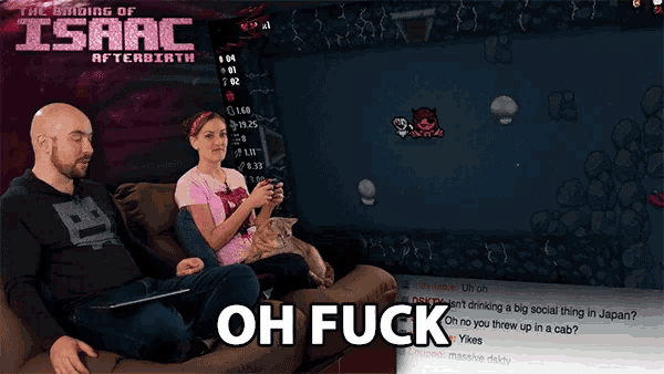 a man and a woman sit on a couch playing a video game called the binding of isaac afterbirth