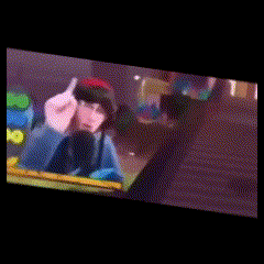 a blurred image of a person pointing at the camera