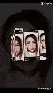 a woman 's face is displayed in a cube on a cell phone