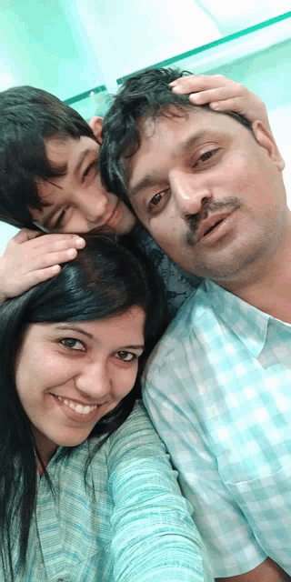 a man and two children pose for a selfie